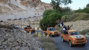 An armed motorcade belonging to members of Derna's Islamic Youth Council, consisting of former members of militias from the town of Derna, drive along a road in Derna, eastern Libya